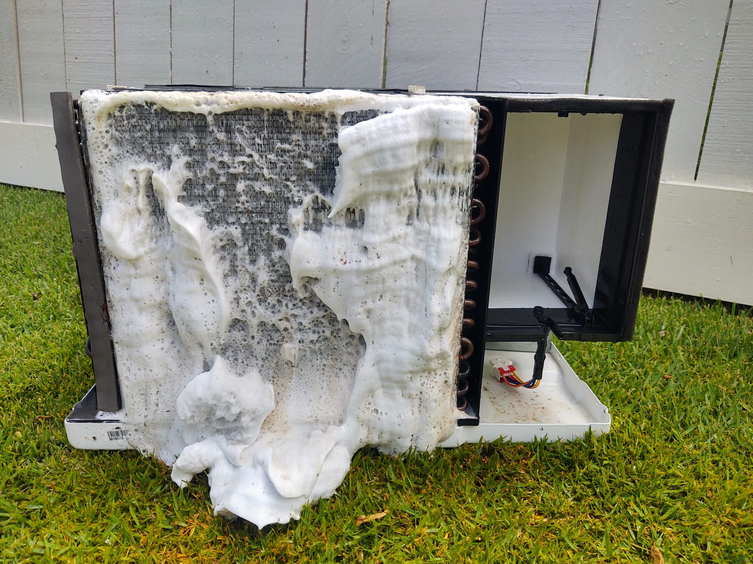 Dirty AC unit being cleaned